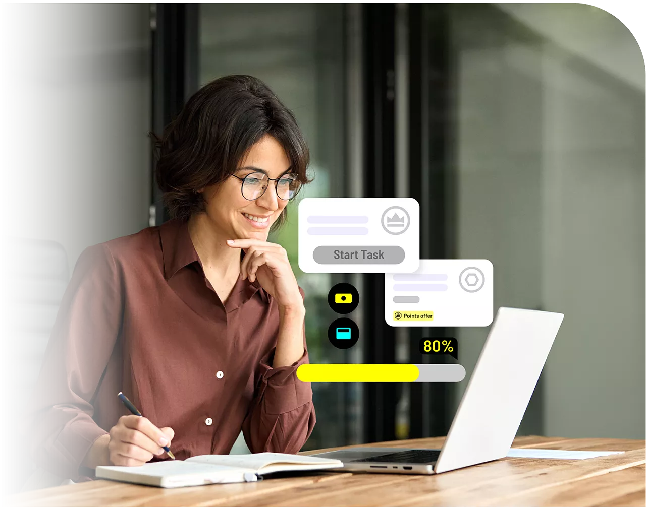 A woman working on tasks on a laptop.