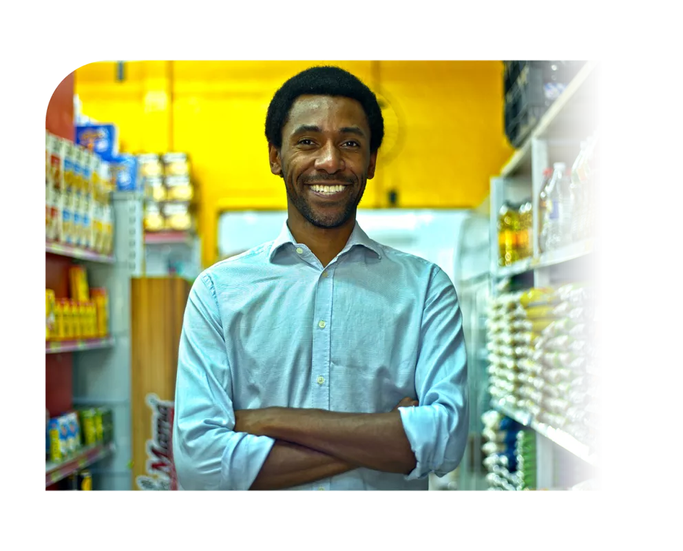A shopkeeper smiling.