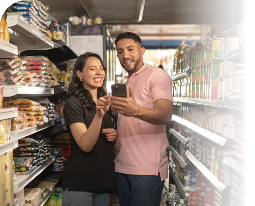 A man and a woman looking at a phone together at a store.